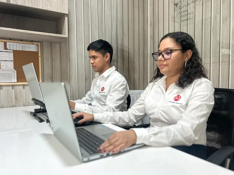 Dos miembros del equipo realizando la constitución de una empresa en su computadora